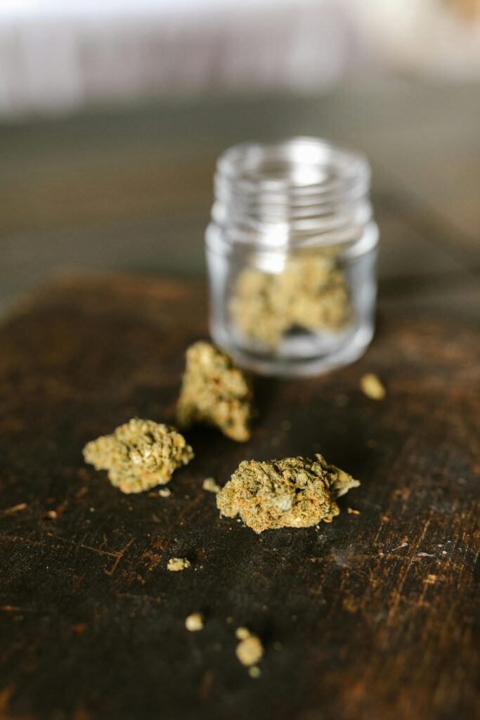 Close-up of cannabis buds spilling from a jar, emphasizing legal use.